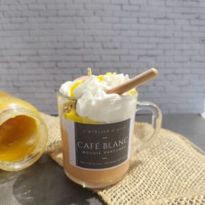 Bougie Café Blanc dans une tasse en verre, avec base orangée à la fleur d'oranger, chantilly blanche, coulis de miel, cuillère à miel et biscuit. Pot de miel en arrière- plan.